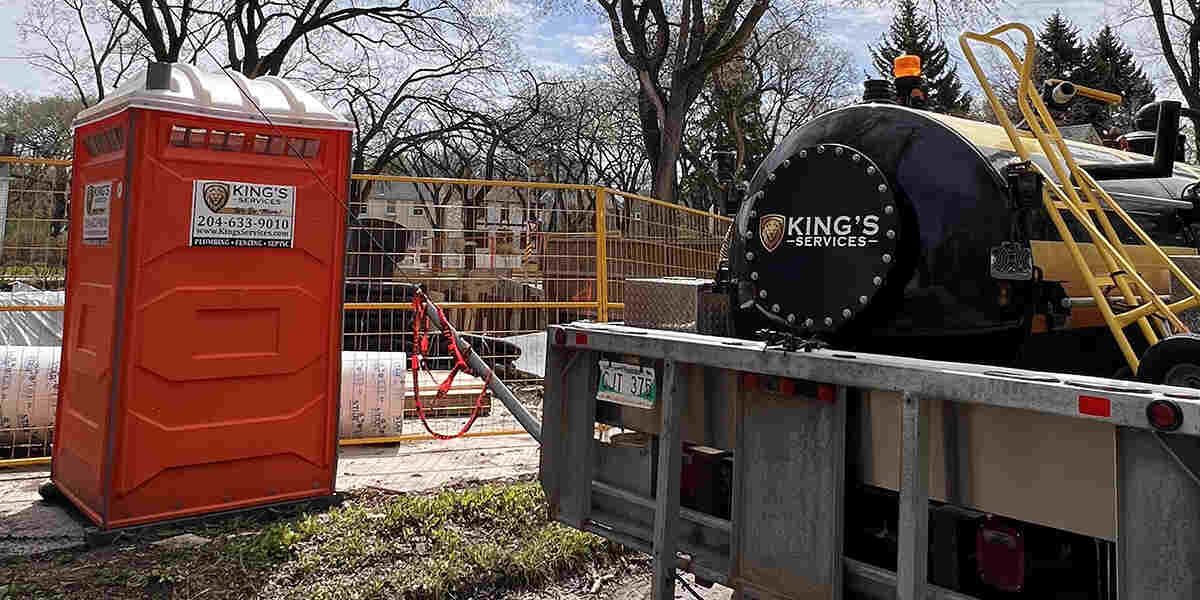 Man standing in front of King's Services van with lion logo. Services: plumbing, drain cleaning, septic service.
